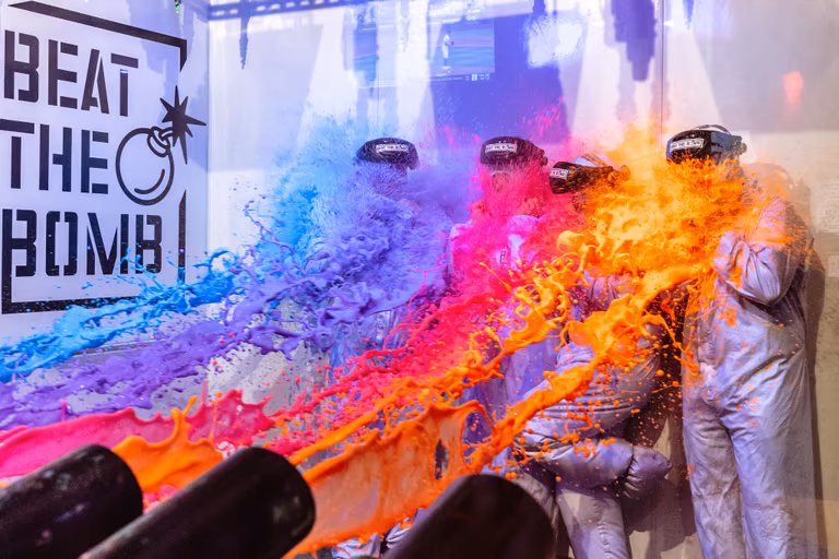 Team getting blasted with orange and blue foam in the Bomb Room