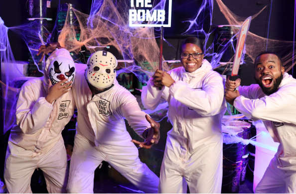 A group in horror masks celebrating among cobwebs