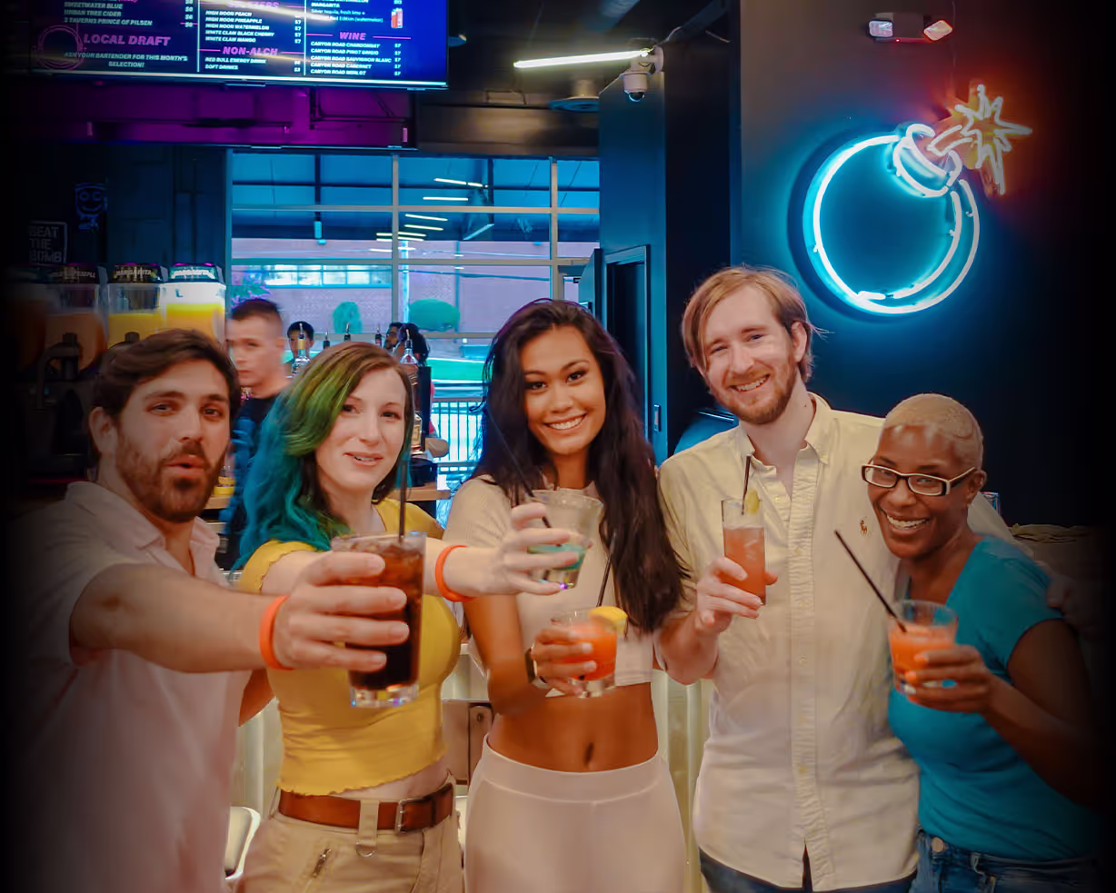 Group of adults cheering with drinks