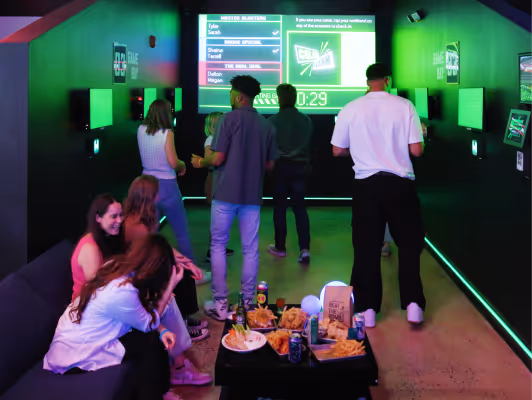 Friends laughing together at Arcade Bomb Battle